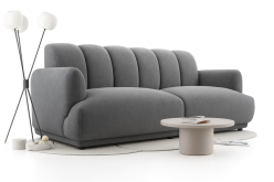 Szara nowoczesna sofa o obłych kształtach na sprężynach