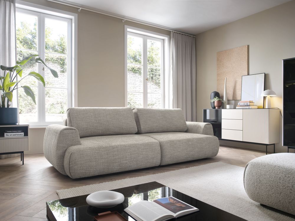 Modna opływowa szara kanapa rozkłądana do spania