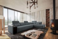Szara sofa rogowa z wydłużonym siedziskiem z funkcją spania